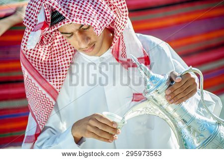 Arbic boy pouring coffee