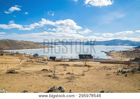 Frozen Shida Bay In March. Tourist Centers On The Shore. Lake Baikal, Siberia, Russia.