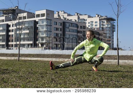 Girl In Green Sports Top And Leggings Trains On The Street, Girl Doing Stretching , Sportswoman, Wor