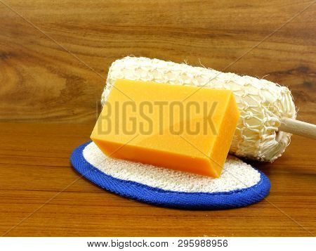 Natural Luff Sponge With Orange Soap On Wooden Background