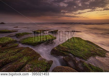 Calm Ocean Long Exposure. Stones Covered By Geen Moss In Mysterious Mist Of The Sea Waves. Concept O