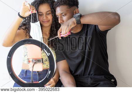Close Up Of A Influencer Couple Deniers Against Coronavirus Fraud.
Focus Of Scissors While Cutting A