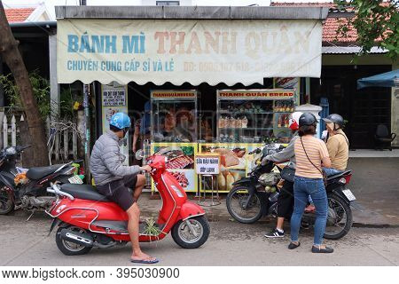 Hoi An, Vietnam, November 16, 2020: Several People On Their Motorbike In The Doorway Of A Restaurant
