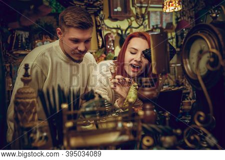 Parrot. Smiling Family, Caucasian Couple Looking For Home Decoration And Holidays Gifts In Household