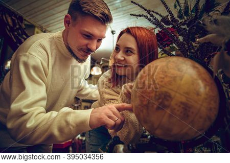 Globe. Smiling Family, Caucasian Couple Looking For Home Decoration And Holidays Gifts In Household 