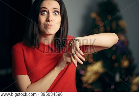 Woman Checking The Time Being Late For Christmas Party