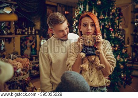 Christmas Tree. Smiling Family, Couple Looking For Home Decoration And Holidays Gifts In Household S