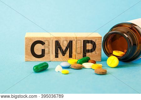 Gmp Good Manufacturing Practice - Inscription On Wooden Cubes