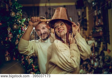 Golden. Smiling Family, Caucasian Couple Looking For Home Decoration And Holidays Gifts In Household