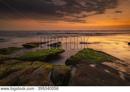 Calm Ocean Long Exposure. Stones Covered By Geen Moss In Mysterious Mist Of The Sea Waves. Concept O