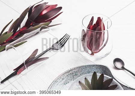 Elegant Table Setting With Floral Decor On White Wooden Background