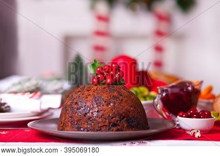 Traditional Christmas Pudding With Holly On Top.