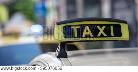 Taxi Sign Yellow Color Detail, Defocused City Street Background
