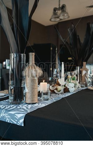 Served Tables For Wedding Banquet With Plates Restaurant. Decor From Fresh Flowers, Coconuts And Lea