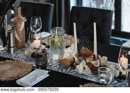 Served Tables For Wedding Banquet With Plates Restaurant. Decor From Fresh Flowers, Coconuts And Lea