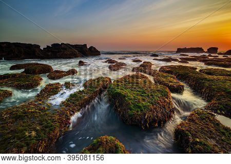 Amazing Seascape. Ocean With Moving Wave. Low Lide. Stones Covered By Green Moss And Seaweeds. Conce