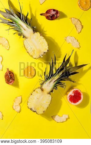Ripe Juicy Pineapple On Yellow Background And Dried Pineapple Wedges Around. Fruit Chips. Healthy Ea