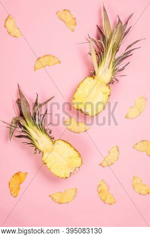 Ripe Juicy Pineapple On Pink Background And Dried Pineapple Wedges Around. Fruit Chips. Healthy Eati