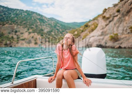 Little Girl Sailing On Boat In Clear Open Sea