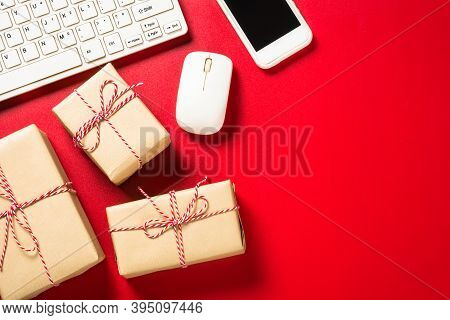 Omline Shopping Concept With Present Boxes, Laptop And Credit Cards At Red Background. Top View With