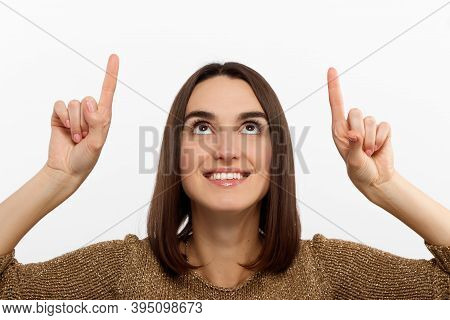 Close-up Portrait Pretty Young Woman Pointing With Two Fingers, Looking At Camera , Isolated On Whit