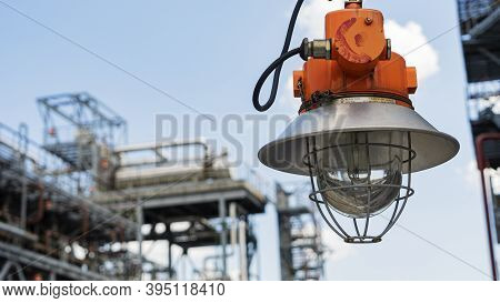 Industrial Explosion Proof Lantern On The Background Of The Refinery Plant And Classic Blue Sky. Spa