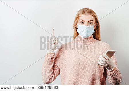 Insight. Important Information. Attention Gesture. Surprised Woman In Medical Mask And Gloves Holdin