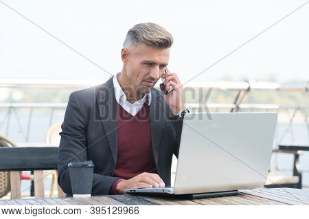 Freelancer Work Laptop Talking On Mobile Phone In Cyber Cafe Outdoors, Freelance.