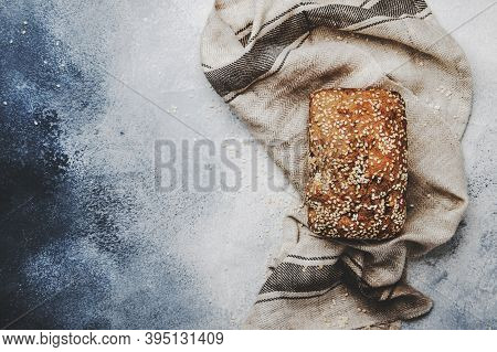 Whole Wheat Organic Rye Dark Bread With Pumpkin Seeds, Dried Fruit, Raisins And Sesame Seeds On Gray