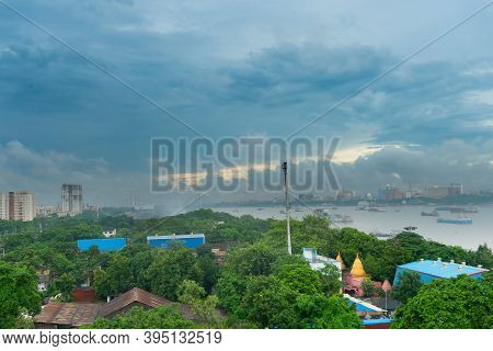 View Of Howrah City From Top. Green Trees In Foreground Covering Factories, Holy River Ganges With F