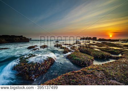 Amazing Seascape. Ocean With Moving Wave. Low Lide. Stones Covered By Green Moss And Seaweeds. Sun O