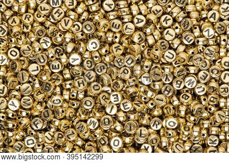 Metallic gold English alphabet beads background