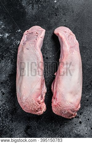 Boiled Pork Tongue. Organic Meat Offal. Black Background. Top View
