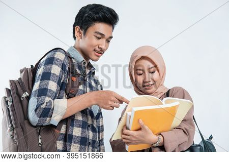 Close Up Of Beautiful Muslim Women Explaining Project On Book To His Partner