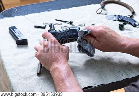 Disassembled Pistol, Safety Cord And Knife. Thorough Cleaning Of The Gun. Pistol And Cleaning Cloth 