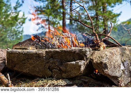 Fishermen's Bivouac On The Island. A Burning Bonfire. Lake Tagasuk.  Siberia, Russia