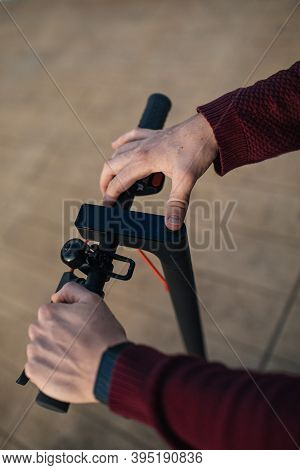Electric Skate With Hands Touching The Buttons. Young Man With An Electric Skate To Move Around The 