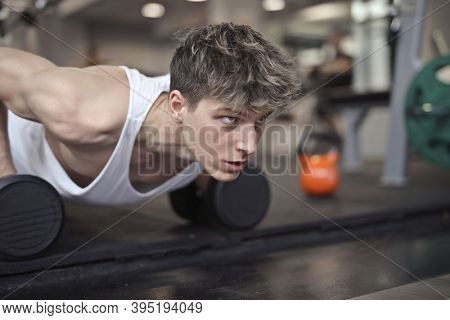 young man during a flexion in the gym