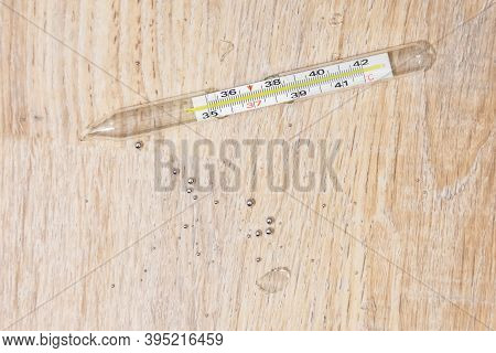 Randomly Broken Medical Thermometer To Measure A Persons Body Temperature, Glass Fragments And Drops