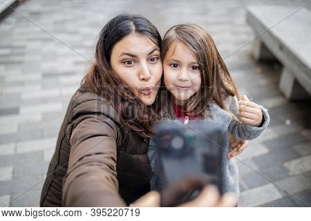 Mother And Daughter Taking A Selfie While Making Funny Faces