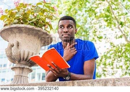 Young African American College Student Studying In New York City, Wearing Blue Short Sleeve T Shirt,