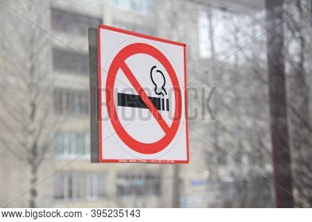 No Smoking Sign On Glass Door, Concept Of Health Care, Smoking Cessation. Smoking Cigarette In A Cro