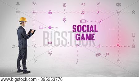 Engineer working on a new social media platform with SOCIAL GAME inscription concept