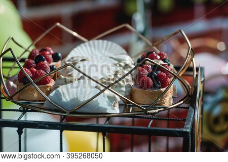 Delicious Dessert: Bavarian Cream With Red And Blue Berries On A White Plate.