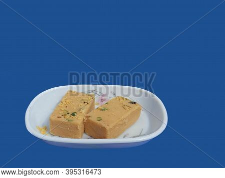 Indian Sweet Dish Sohan Papdi  Kept On White Plate. Vegetarian Sweet Made Of Sugar Gram Flour, All P
