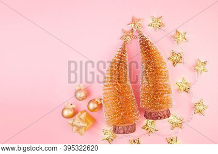 Christmas Gold Glitter Background With Christmas Trees, Decorations, Stars Garland On Soft Light Pin