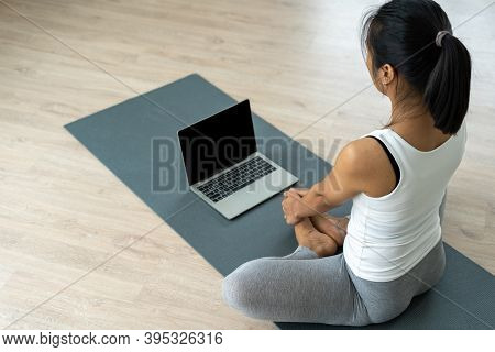 Slim Asian Girls Are Doing Yoga And Watching Video Tutorials On Tablat. Women Practicing Yoga Poses 