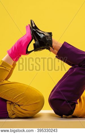 Jocosity. Fashion Model's Feet In Bright Stylish Footwear White, Pink Isolated On Yellow Background.