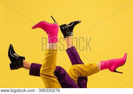 Jocosity. Fashion Model's Feet In Bright Stylish Footwear White, Pink Isolated On Yellow Background.