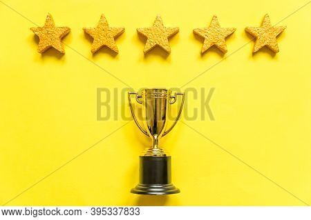 Simply Flat Lay Design Winner Or Champion Gold Trophy Cup And 5 Stars Rating Isolated On Yellow Back